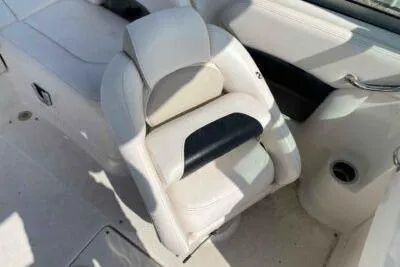 Slide: The Image of 2008 Chaparral Sunesta 224 boat interior with white seating and cup holder. - 9