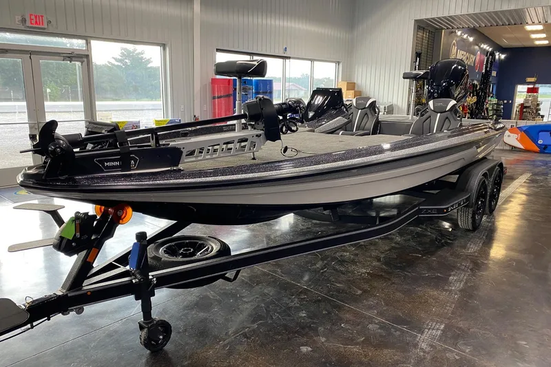 Slide: The Image of 2026 Skeeter ZXE21 fishing boat displayed indoors on a trailer. - 3