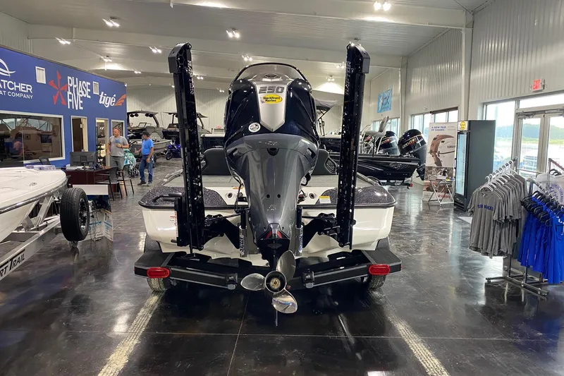 Slide: The Image of 2026 Skeeter ZXE21 boat displayed in showroom with powerful outboard motor. - 4