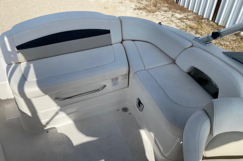 Slide: The Image of 2008 Chaparral Sunesta 224 boat interior with white cushioned seating. - 10