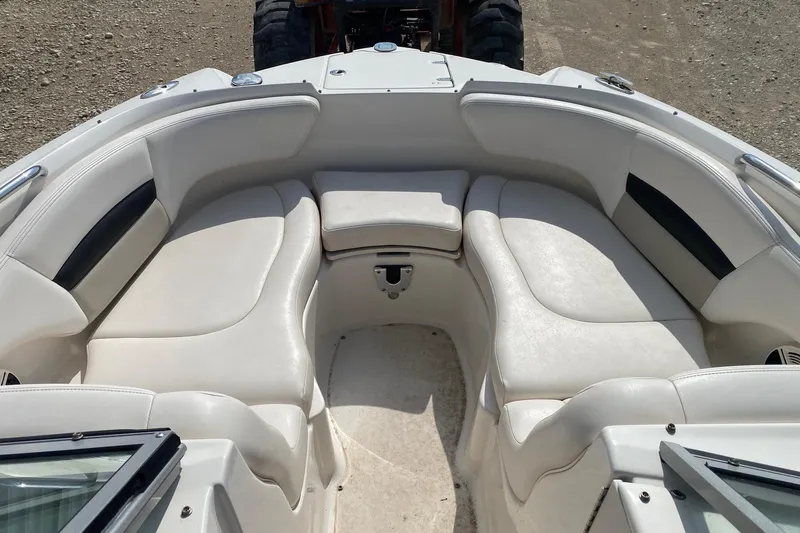 Slide: The Image of 2008 Chaparral Sunesta 224 boat interior with white cushioned seating. - 16