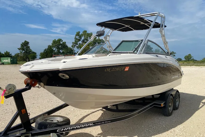 Slide: The Image of 2008 Chaparral Sunesta 224 boat on trailer, parked outdoors under a clear sky. - 2