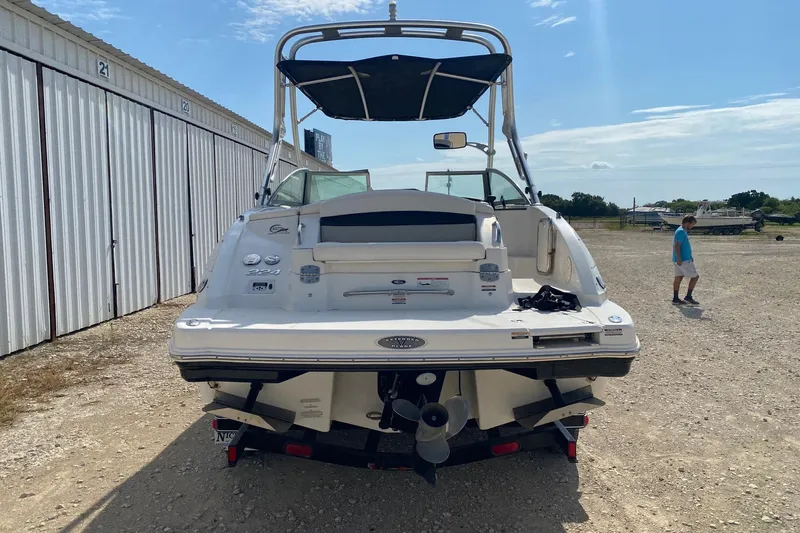 Slide: The Image of 2008 Chaparral Sunesta 224 boat parked outdoors near storage units. - 4