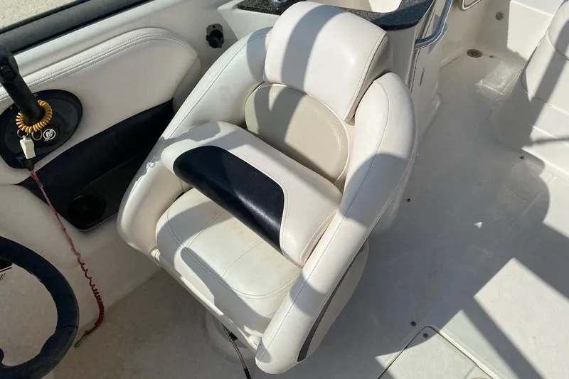 Slide: The Image of 2008 Chaparral Sunesta 224 boat interior with white and black captain's chair. - 7