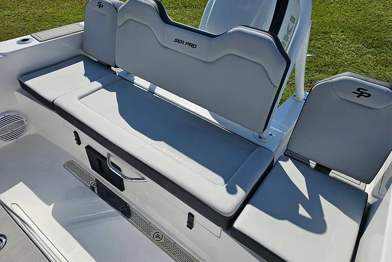 Slide: The Image of 2026 Sea Pro 245 Sandbar boat seating area with cushioned seats and storage. - 11