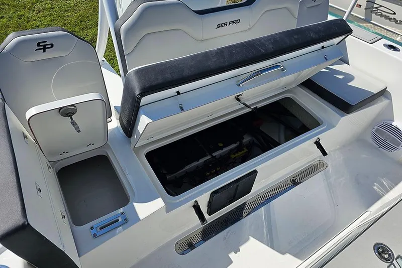 Slide: The Image of 2026 Sea Pro 245 Sandbar boat interior with open storage compartments and seating. - 12