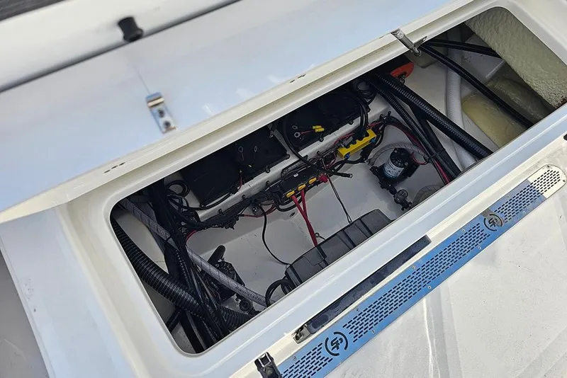 Slide: The Image of Open hatch of 2026 Sea Pro 245 Sandbar boat showing internal wiring and components. - 13
