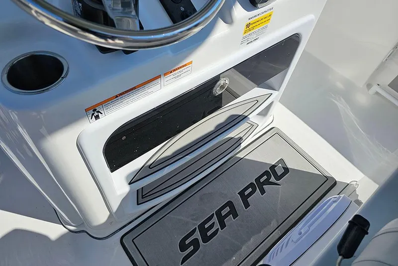 Slide: The Image of 2026 Sea Pro 245 Sandbar boat console with steering wheel and branded mat. - 17