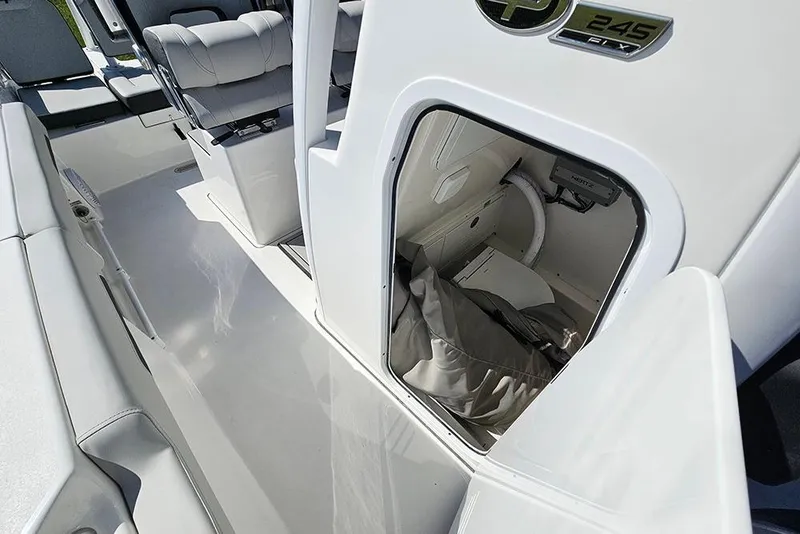 Slide: The Image of 2026 Sea Pro 245 Sandbar boat interior with open storage compartment and seating. - 21