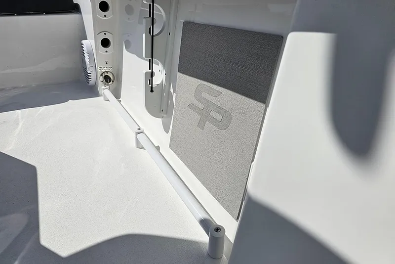 Slide: The Image of 2026 Sea Pro 245 Sandbar boat interior with storage and logo detail. - 26