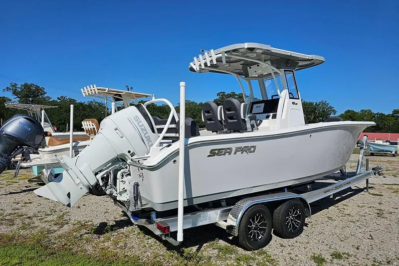 Slide: The Image of 2026 Sea Pro 245 Sandbar boat on trailer, featuring Suzuki outboard motor. - 3