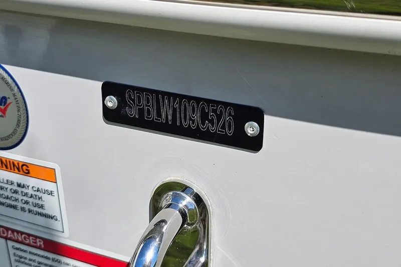 Slide: The Image of 2026 Sea Pro 245 Sandbar boat identification plate with warning labels. - 35