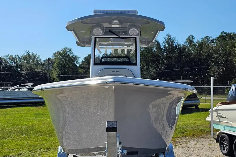 Slide: The Image of 2026 Sea Pro 245 Sandbar boat on trailer, front view, outdoors. - 4
