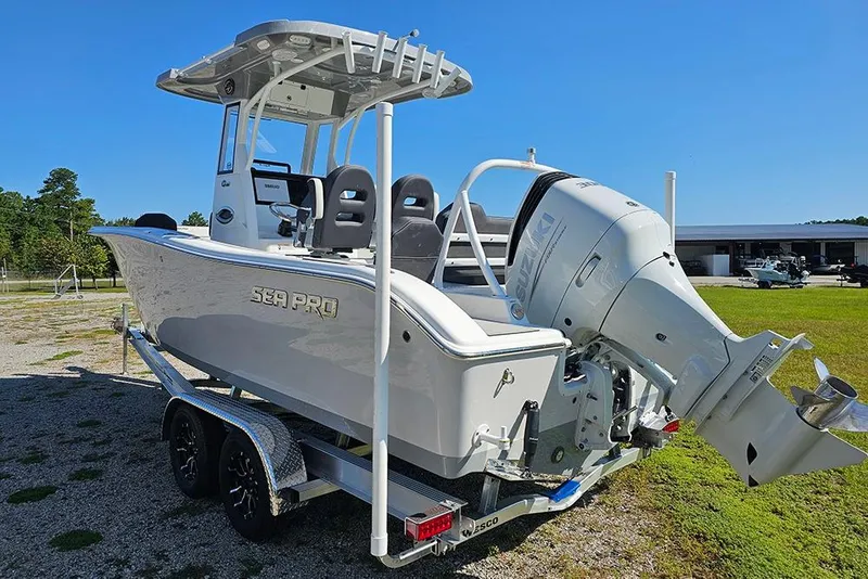 Slide: The Image of 2026 Sea Pro 245 Sandbar boat on trailer, featuring Suzuki outboard motor. - 7