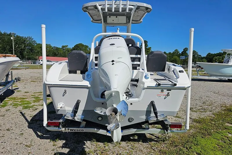 Slide: The Image of 2026 Sea Pro 245 Sandbar boat, rear view with motor, parked outdoors. - 8