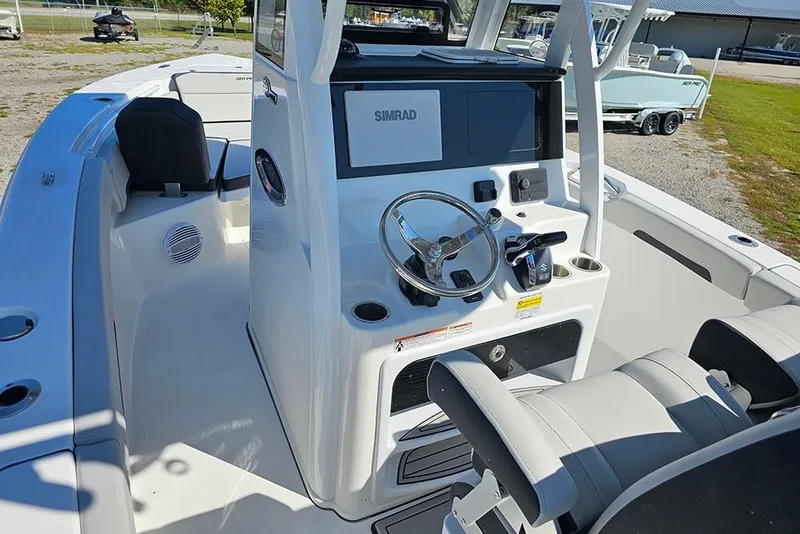 Slide: The Image of 2026 Sea Pro 245 Sandbar boat interior with steering console and seating. - 9