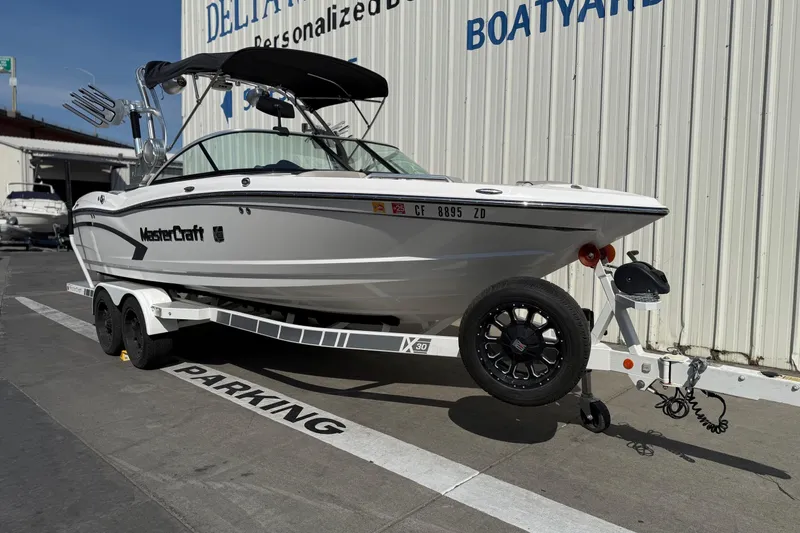 Slide: The Image of 2015 MasterCraft X30 boat on trailer, parked at a boatyard. - 1