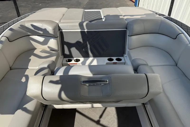 Slide: The Image of 2015 MasterCraft X30 boat interior with white leather seating and cup holders. - 15