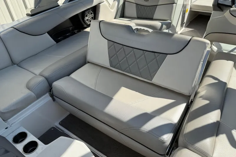 Slide: The Image of 2015 MasterCraft X30 interior with gray leather seating and cup holders. - 16