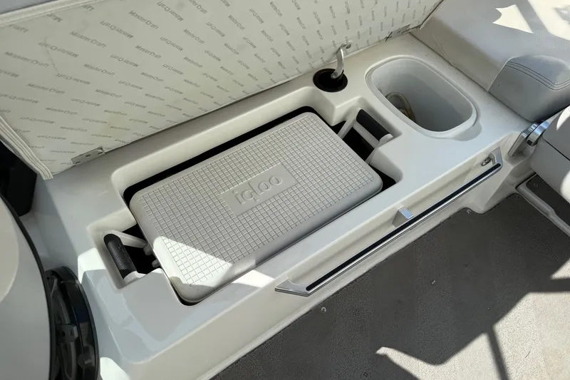 Slide: The Image of 2015 MasterCraft X30 boat interior with Igloo cooler storage compartment. - 18