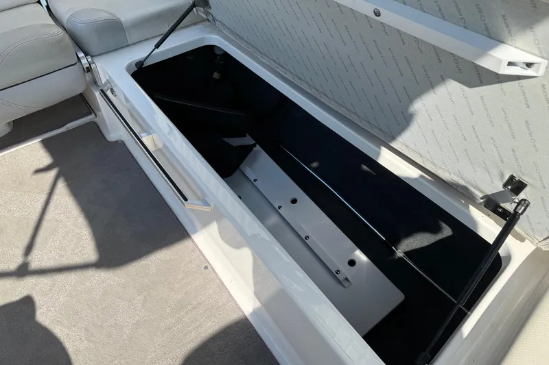 Slide: The Image of Open storage compartment in 2015 MasterCraft X30 boat interior. - 19