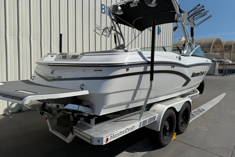 Slide: The Image of 2015 MasterCraft X30 boat on trailer, parked outdoors, side and rear view. - 5