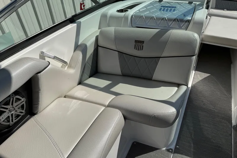 Slide: The Image of 2015 MasterCraft X30 boat interior with gray seating and speaker system. - 7