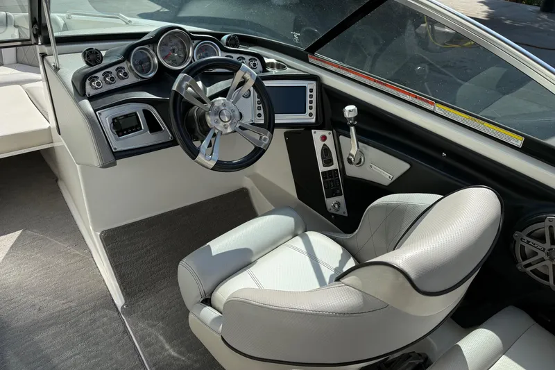 Slide: The Image of 2015 MasterCraft X30 boat interior with steering wheel and control panel. - 8