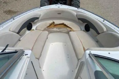 Slide: The Image of 2004 Chaparral 230 SSi boat interior with worn seating and speakers. - 7