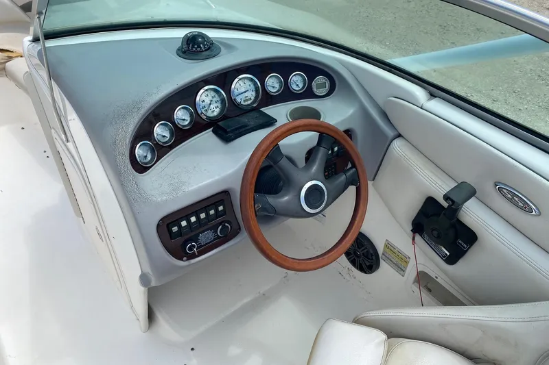 Slide: The Image of 2004 Chaparral 230 SSi boat dashboard with wood steering wheel and instrument panel. - 7
