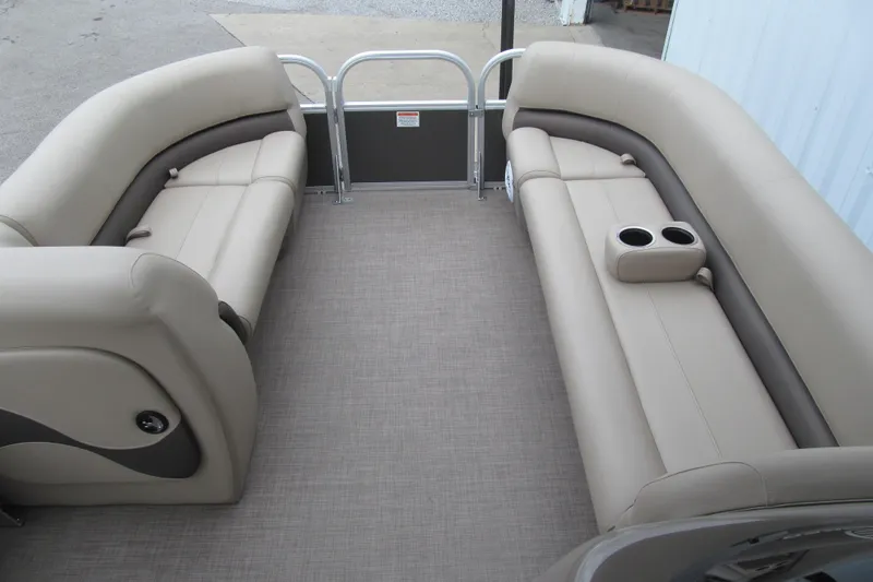 Slide: The Image of 2023 Sun Tracker Party Barge 18 DLX interior with beige seating and cup holders. - 7