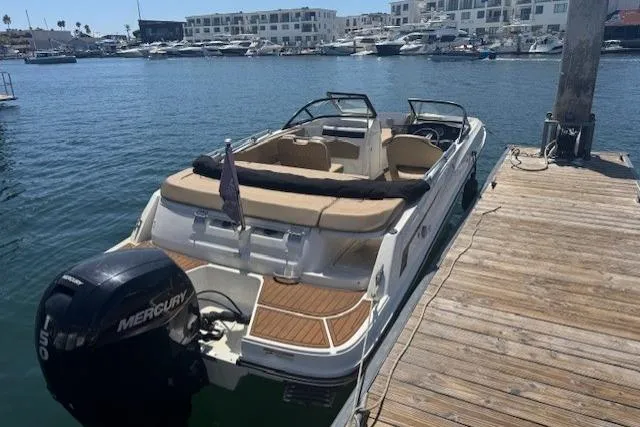 Slide: The Image of 2023 Bayliner VR5 Bowrider OB docked, featuring a Mercury outboard motor. - 2