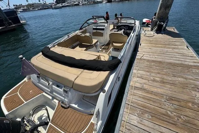 Slide: The Image of 2023 Bayliner VR5 Bowrider OB docked, featuring spacious seating and sleek design. - 3
