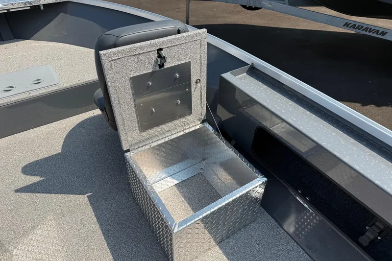 Slide: The Image of 2026 Fish Rite Angler 18 boat deck with storage compartment, featuring durable, textured surface. - 3