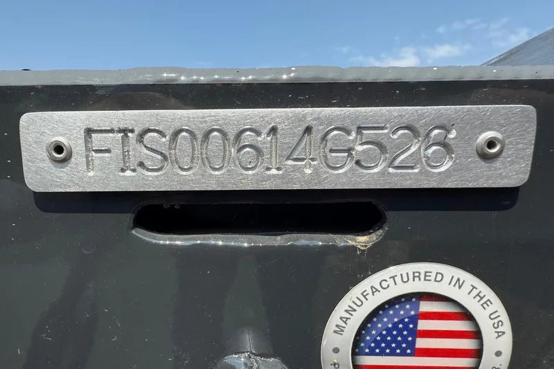 Slide: The Image of Open storage compartment in 2026 Fish Rite Angler 18 boat, featuring diamond plate design. - 7