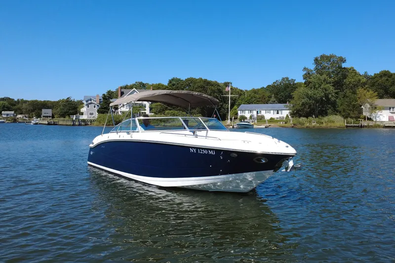 The Image of 2012 Cobalt 296 boat on calm water with houses in the background. - 0