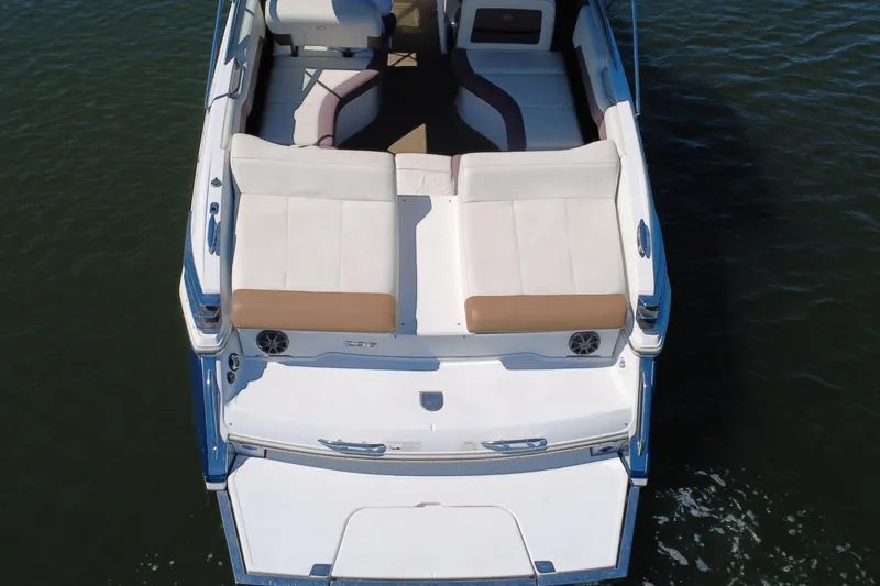 Slide: The Image of 2012 Cobalt 296 boat with spacious seating and swim platform on calm water. - 12