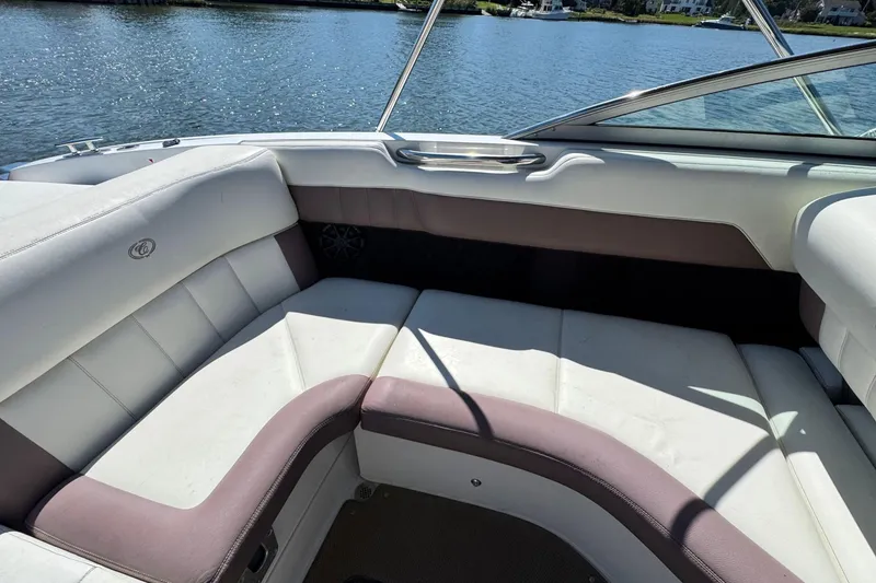 Slide: The Image of Interior seating of a 2012 Cobalt 296 boat, featuring white and brown upholstery. - 15