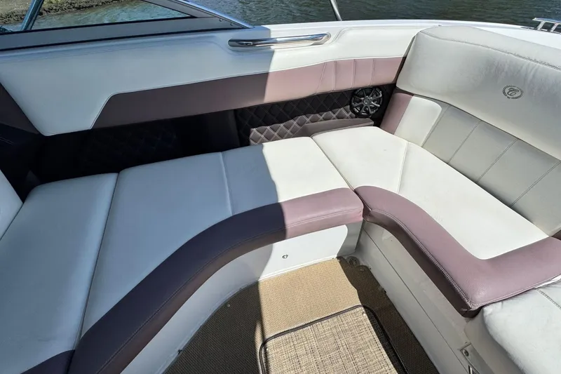 Slide: The Image of Interior seating of a 2012 Cobalt 296 boat with white and purple upholstery. - 16