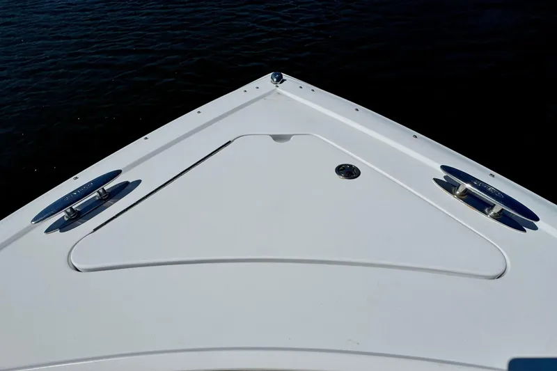 Slide: The Image of Bow of a 2012 Cobalt 296 boat on calm water, featuring sleek design elements. - 31