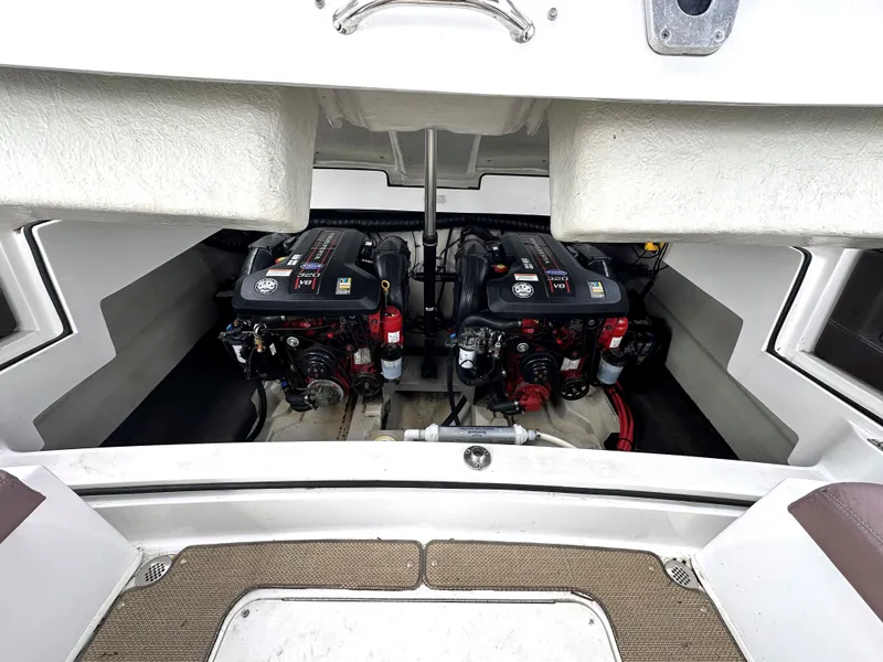 Slide: The Image of 2012 Cobalt 296 boat engine compartment with twin engines. - 33