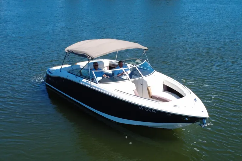 Slide: The Image of 2012 Cobalt 296 boat cruising on calm blue water with two passengers. - 8