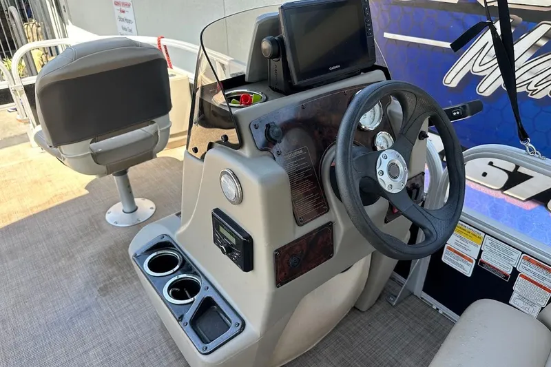 Slide: The Image of 2022 Sun Tracker Bass Buggy 18 DLX boat dashboard with steering wheel and controls. - 19