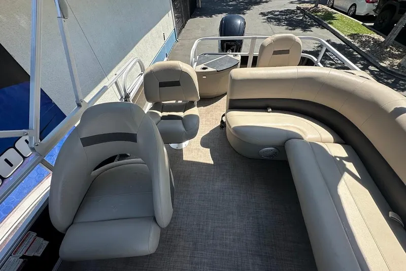 Slide: The Image of 2022 Sun Tracker Bass Buggy 18 DLX pontoon boat interior with beige seating. - 21