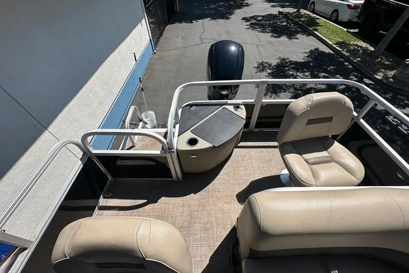 Slide: The Image of 2022 Sun Tracker Bass Buggy 18 DLX pontoon boat interior with beige seating. - 22