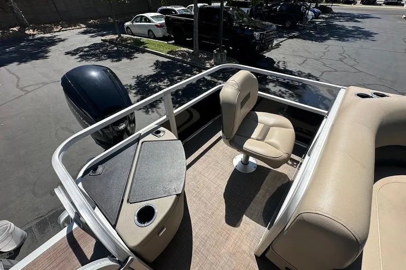 Slide: The Image of 2022 Sun Tracker Bass Buggy 18 DLX pontoon boat interior with seating and motor. - 23