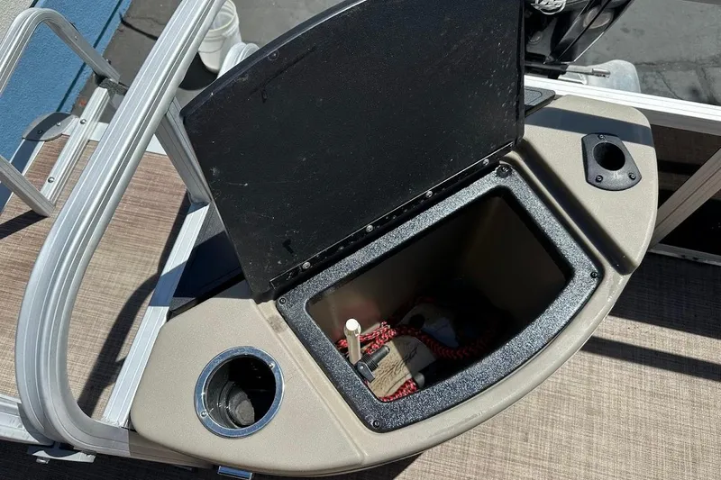 Slide: The Image of Open storage compartment on 2022 Sun Tracker Bass Buggy 18 DLX pontoon boat. - 25