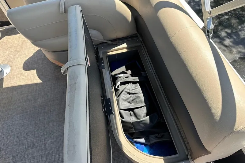 Slide: The Image of Open storage compartment on 2022 Sun Tracker Bass Buggy 18 DLX pontoon boat seat. - 27
