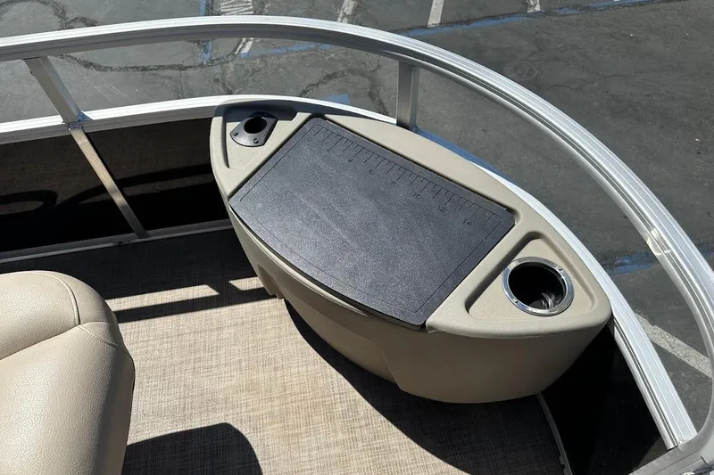 Slide: The Image of 2022 Sun Tracker Bass Buggy 18 DLX boat interior with cup holders and measuring board. - 30