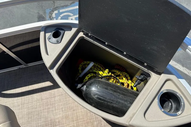Slide: The Image of Storage compartment on 2022 Sun Tracker Bass Buggy 18 DLX pontoon boat with cup holders. - 31